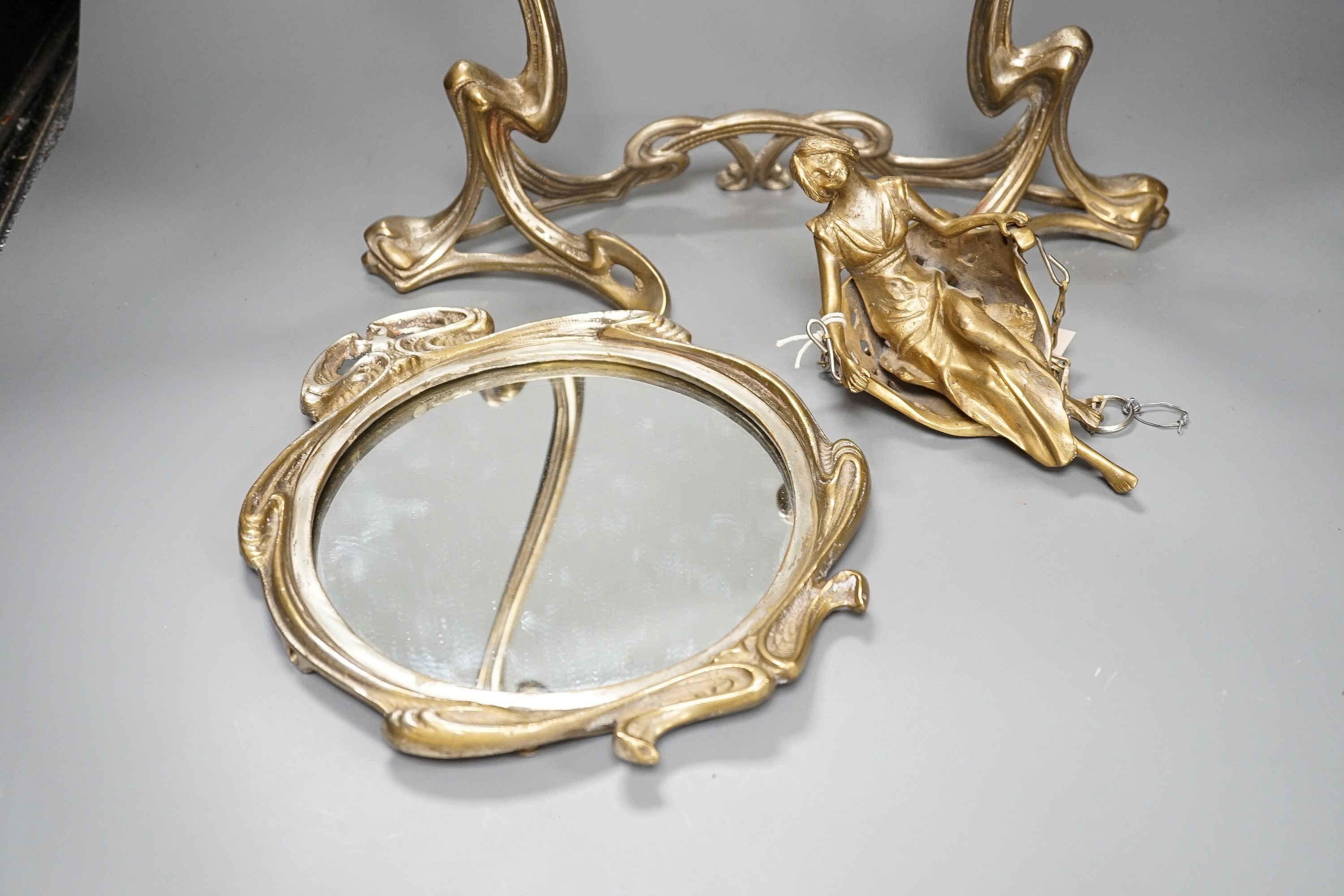 An Art Nouveau style mirror with model of girl sitting on a swing, height 45cm